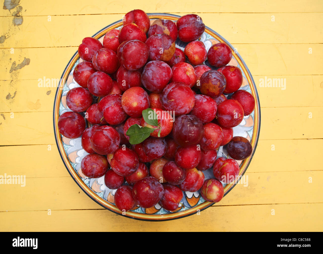 A plate of fresh plums. Stock Photo