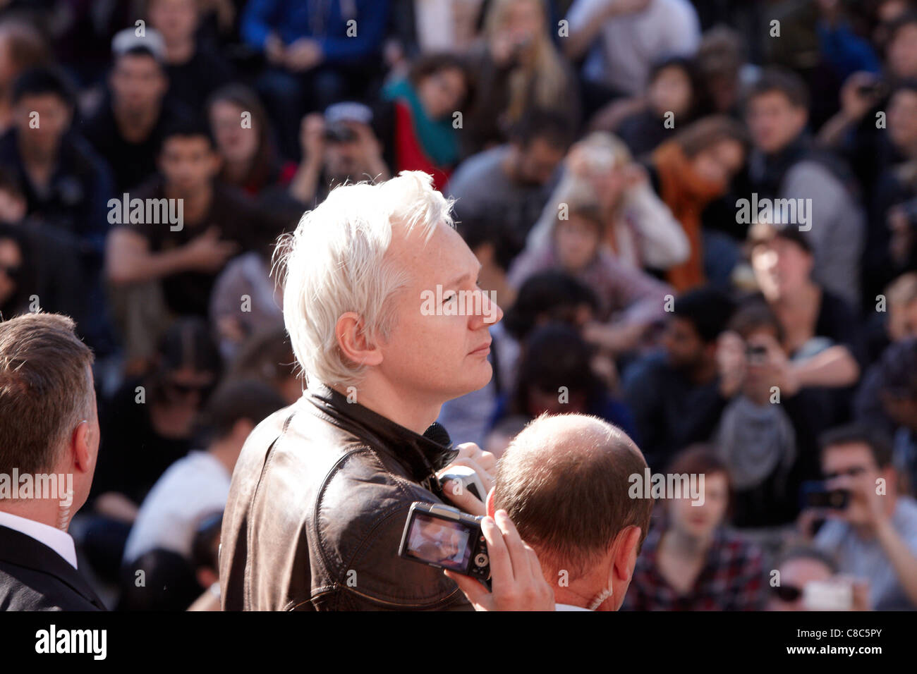 Julian Assange (C) addresses the crowd from the steps of St Pauls Cathedral as part of the Occupy London Stock Exchange protest Stock Photo