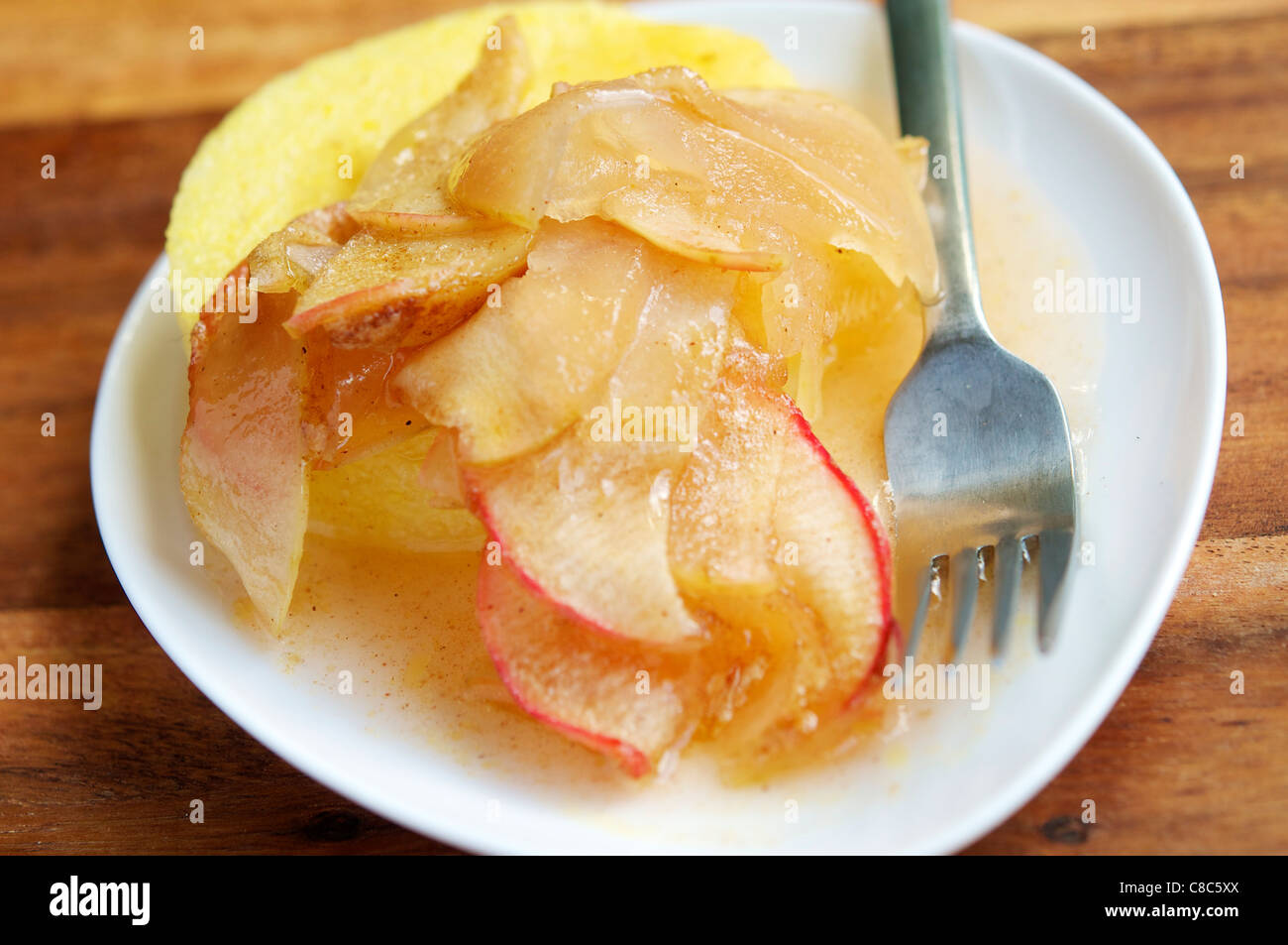 Vegan Polenta with caramelized apples. Stock Photo