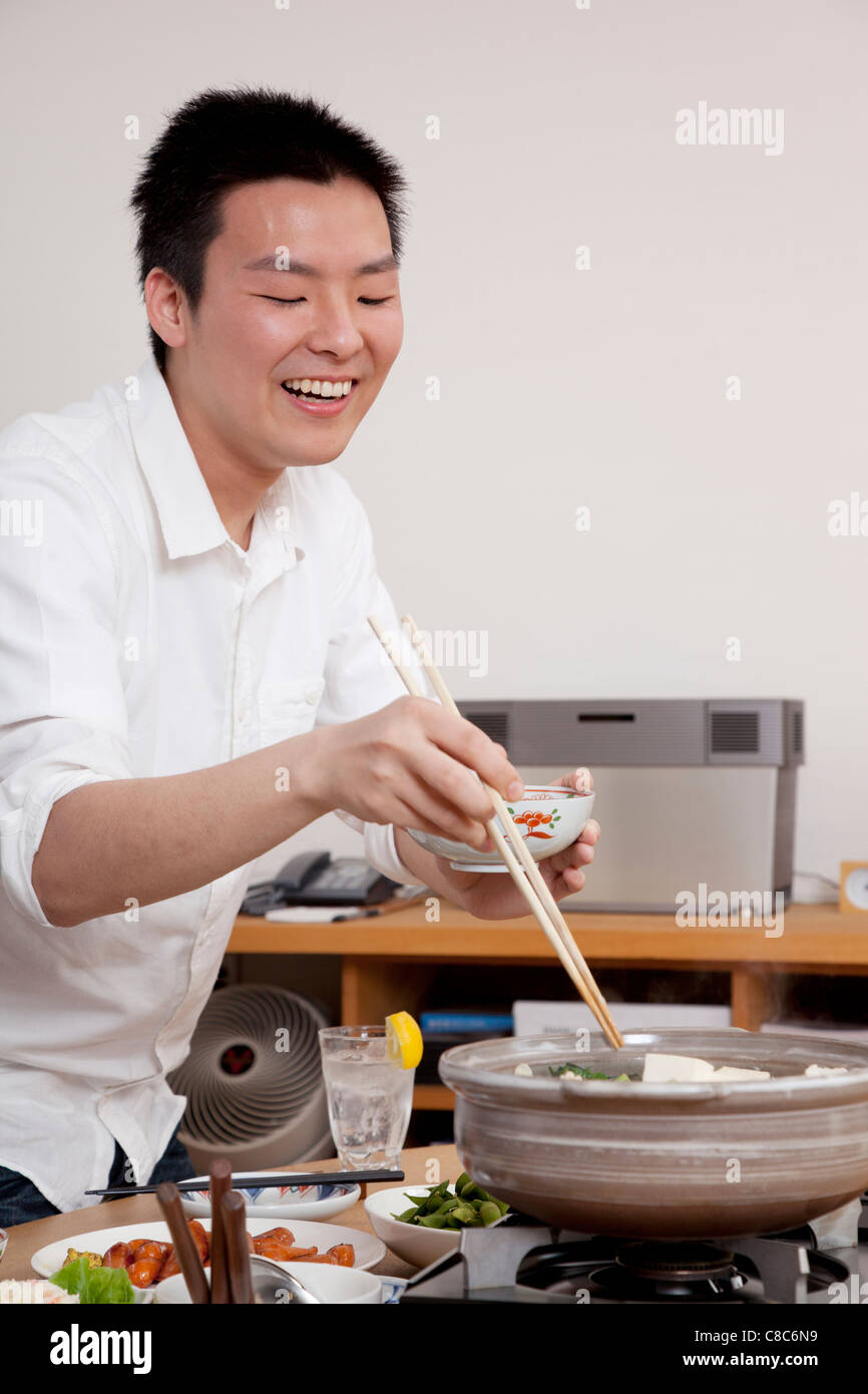 Young man serving hot pot hires stock photography and images Alamy