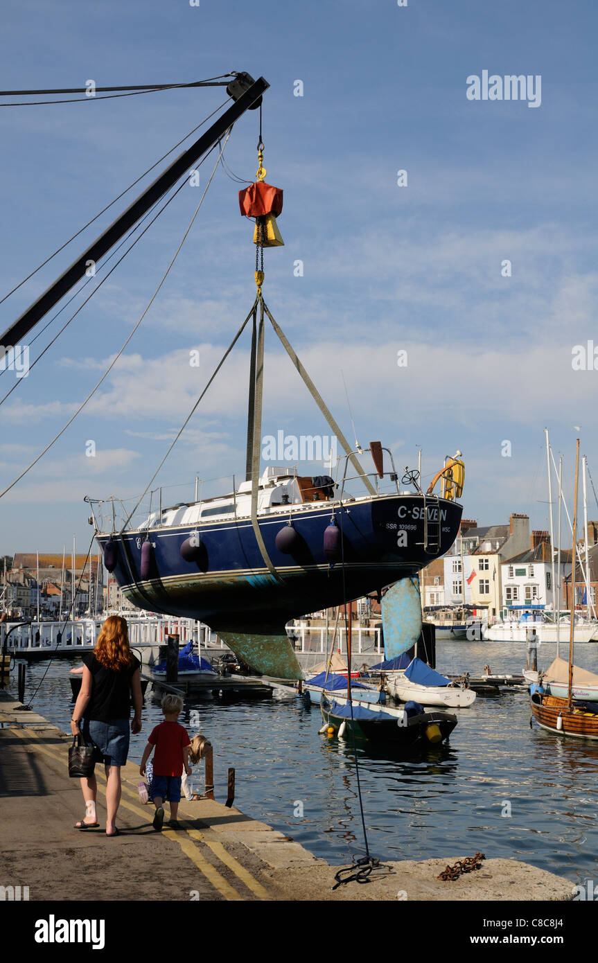 Sailing boat being lifted from the water for cleaning Weymouth Harbour