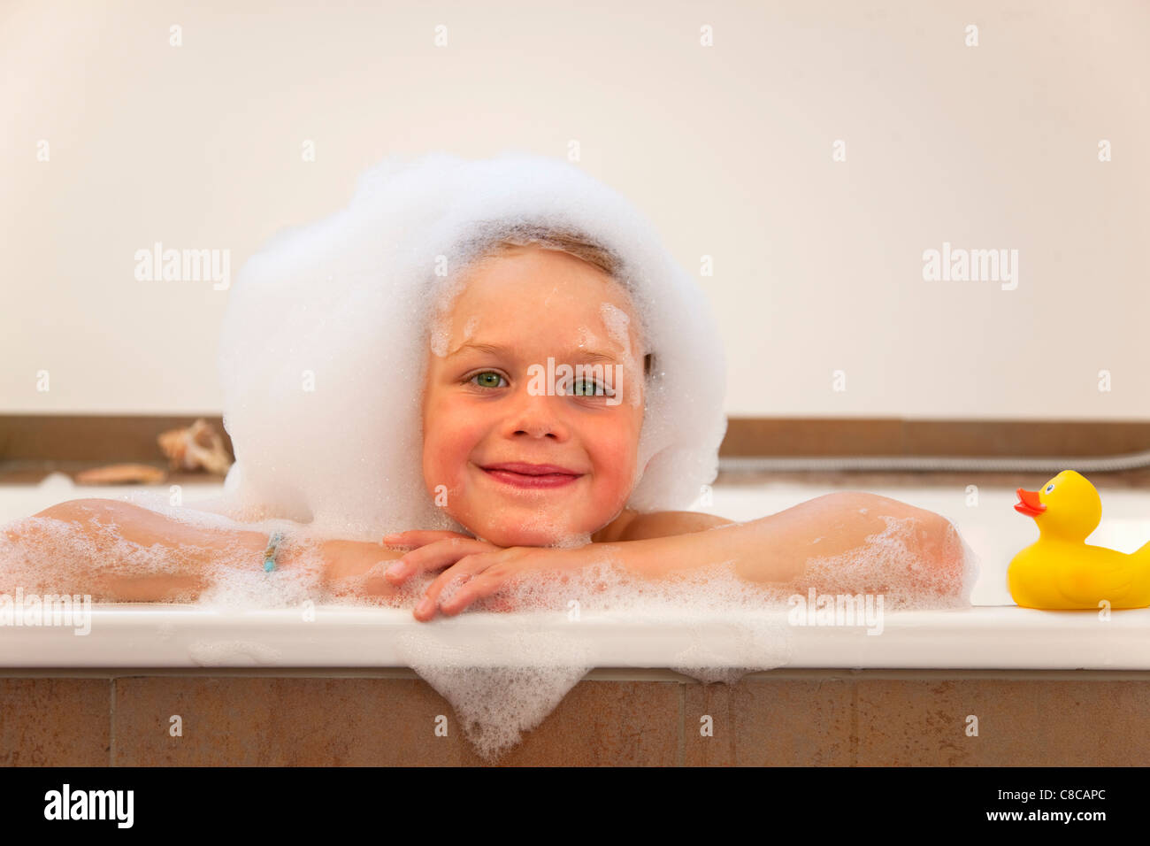 Boy covered in bubbles in bathtub Stock Photo Alamy