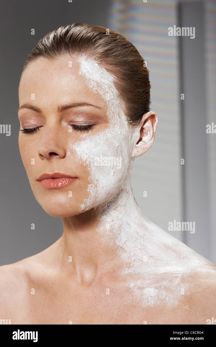 Woman with moisturizer on face and neck Stock Photo Alamy