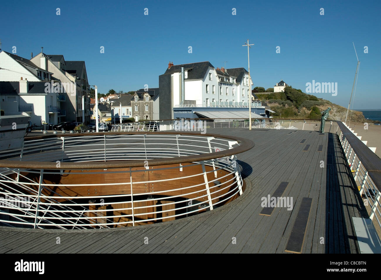 Jacques Tati statue looks out from the promenade over the beach at Saint-Marc-Sur-Mer, Brittany, France Stock Photo