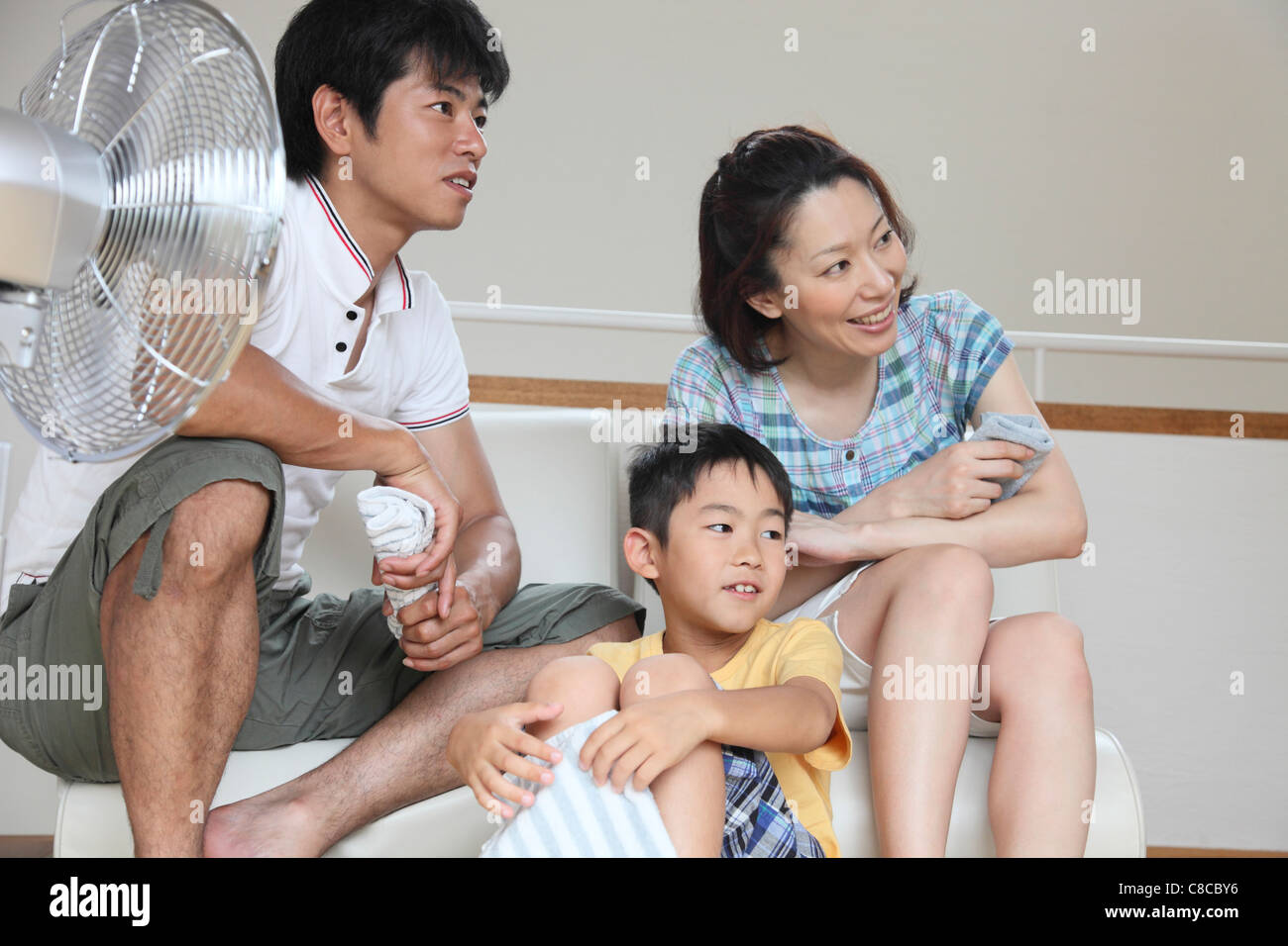Family relaxing at living room Stock Photo