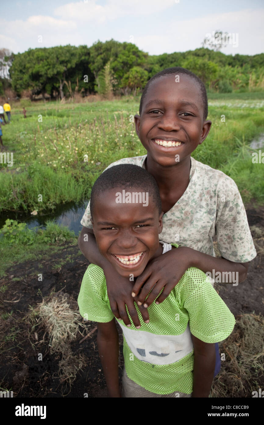 Two school boys stand in an open field in Mongu, Zambia, Southern Africa. Stock Photo