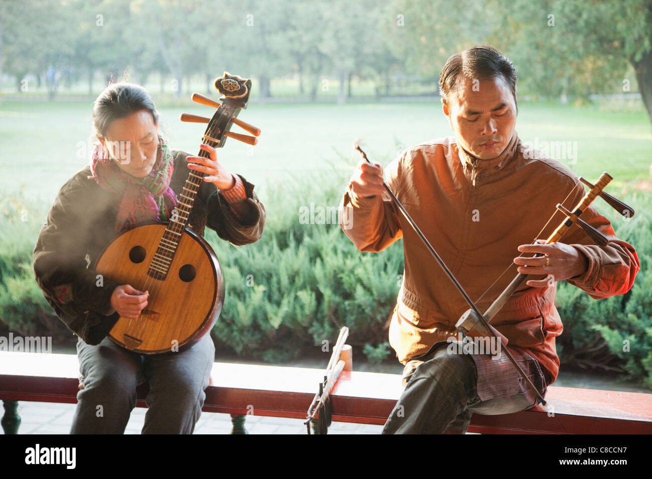 China, Beijing, Temple of Heaven Park, Man and Woman Playing Traditional Chinese Stringed Instruments Stock Photo