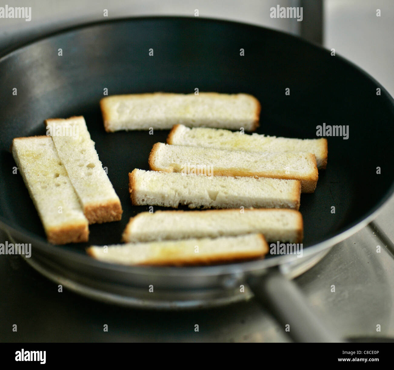 Man toasting bread in pan Stock Photo Alamy