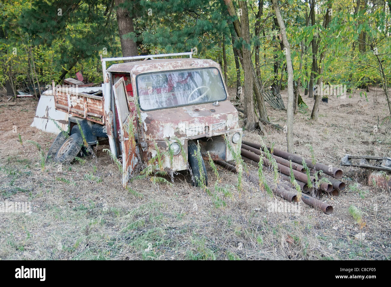 Old rusty three-wheeler abandoned in a forest Stock Photo - Alamy