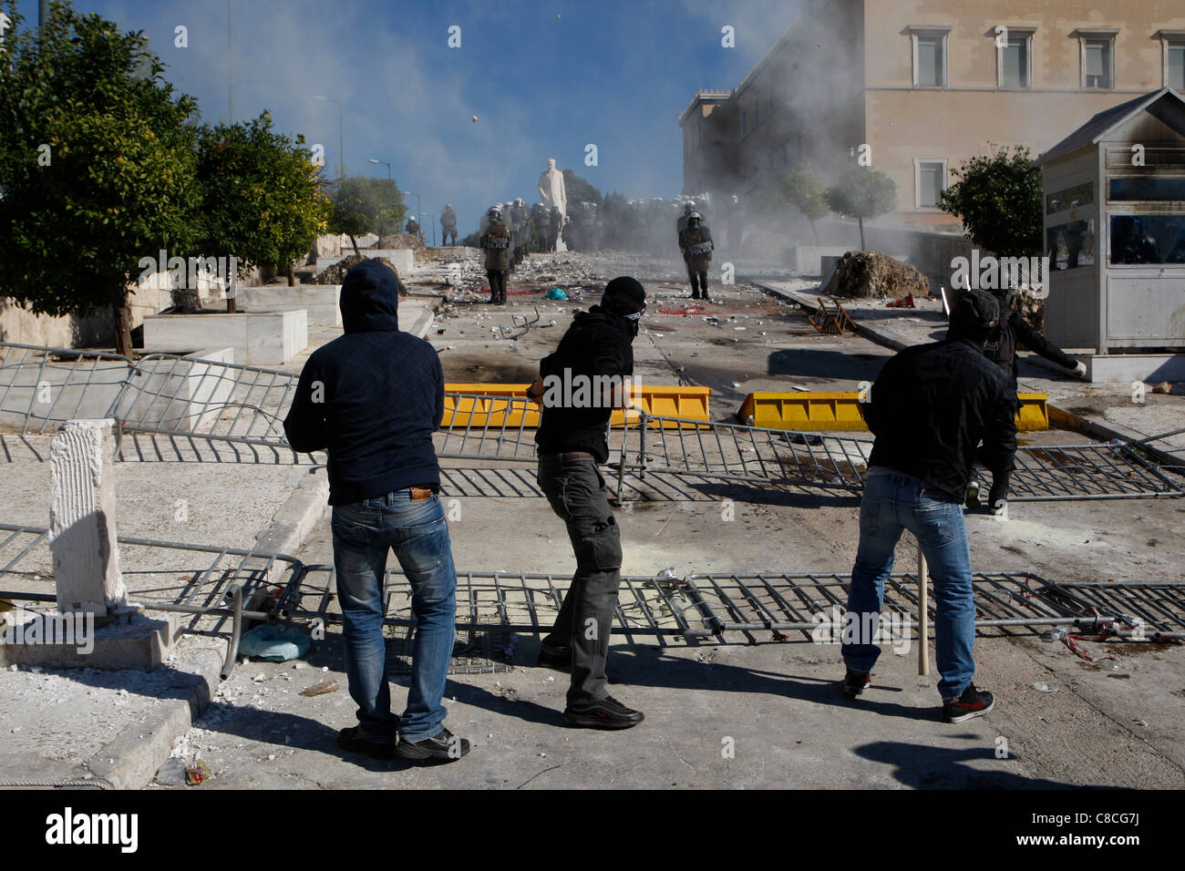 Athens Greece, 19/10/2011. Protesters clash with riot police, throwing fire bombs and stones. They were among thousands of people protesting in the Greek capital against proposed austerity measures. Stock Photo