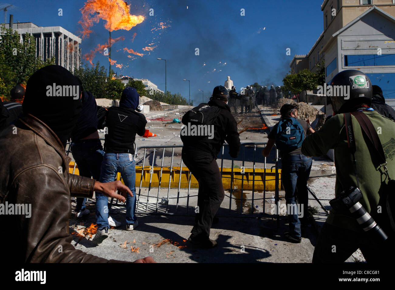Athens Greece, 19/10/2011. Protesters clash with riot police outside the Greek Parliament, throwing fire bombs and stones. They were among thousands of people protesting in the Greek capital against proposed austerity measures. Stock Photo