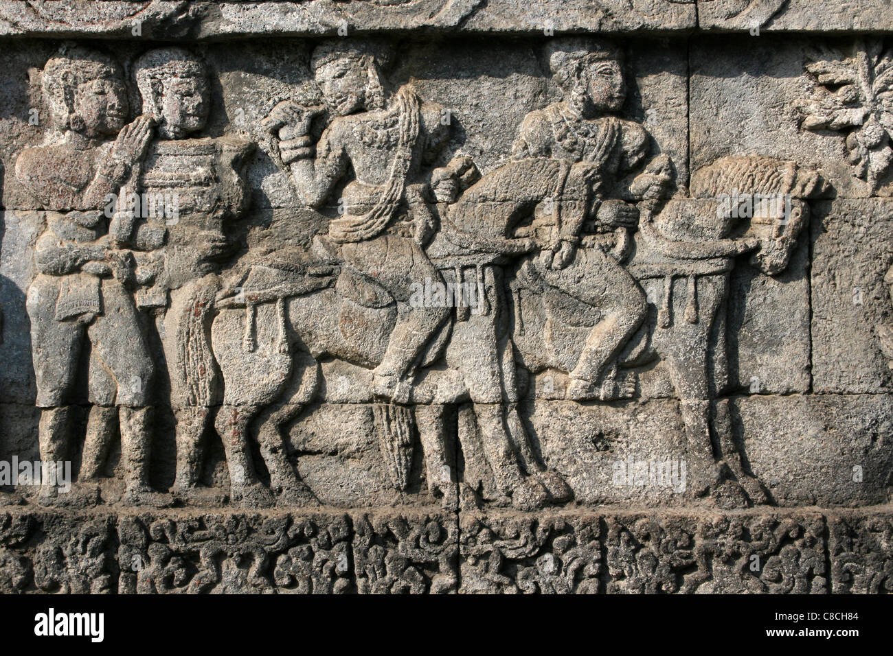 Stone Temple Relief Of Men On Horseback, Penataran Temple Java Stock Photo
