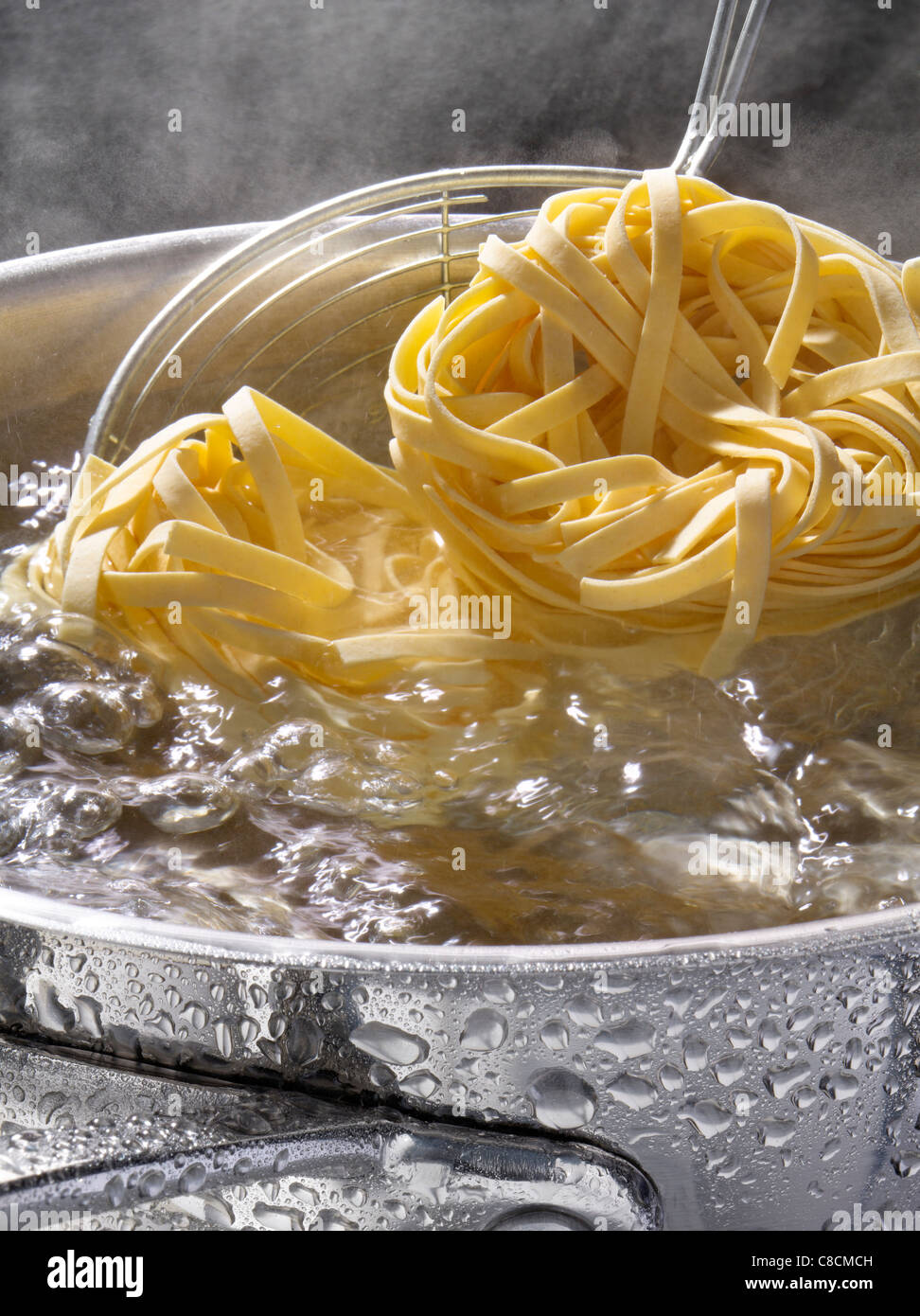 Cooking pasta in boiling water Stock Photo Alamy