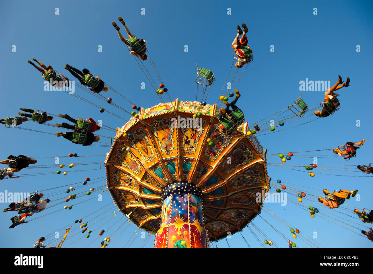 world famous Oktoberfest in Munich, Germany, with carousel and flying people Stock Photo