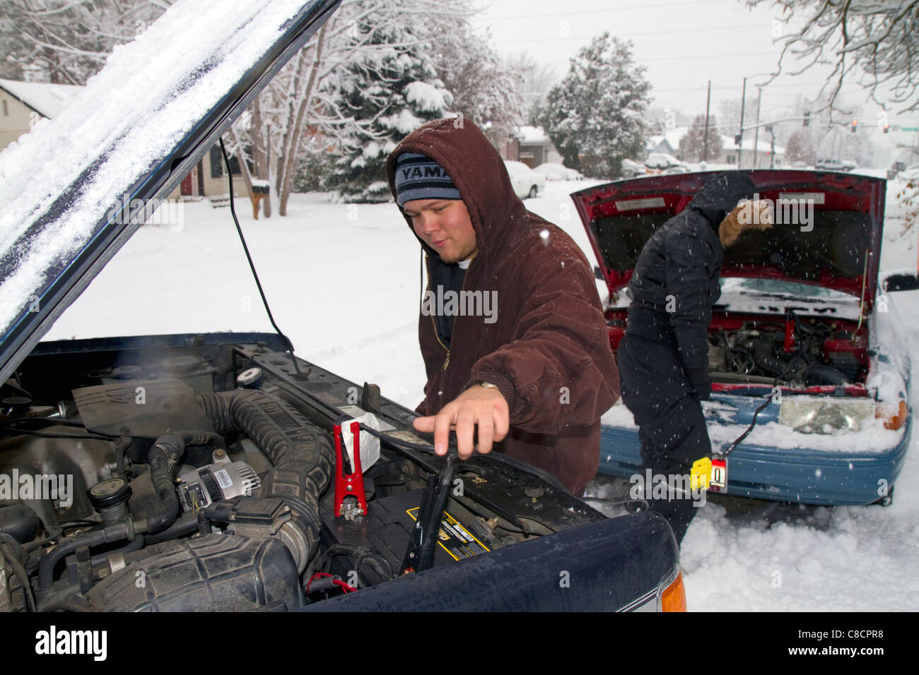 Jump starting a car in winter weather, Boise, Idaho, USA. Stock Photo