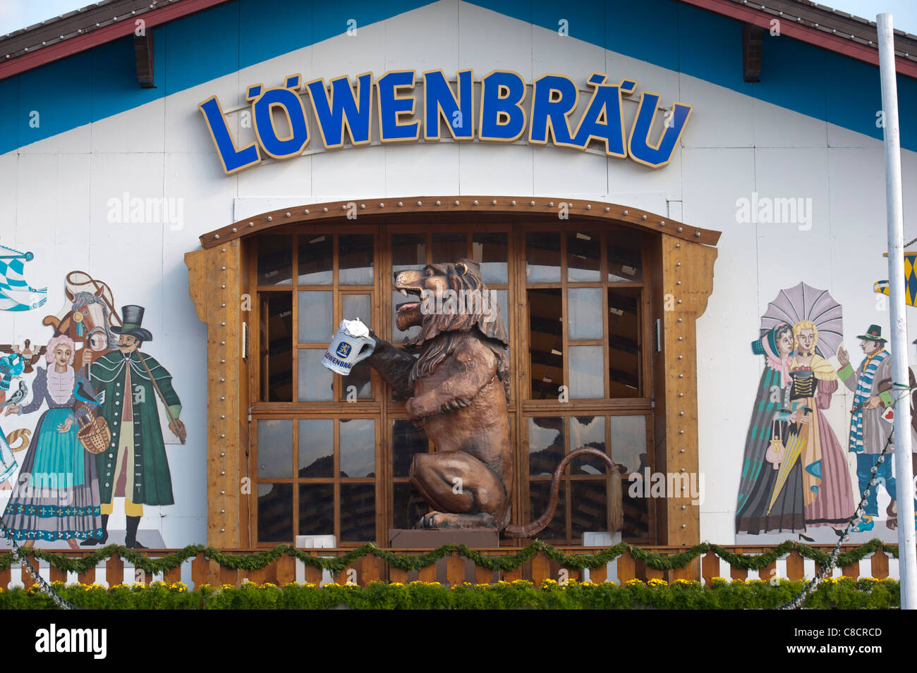 world famous Oktoberfest in Munich, Germany, with lion figure at entrance to Löwenbräu brewery beer hall Stock Photo