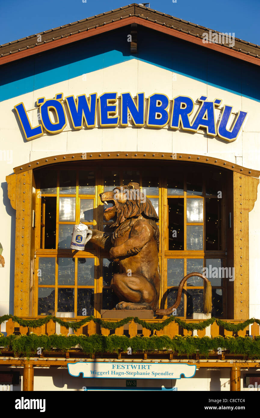 world famous Oktoberfest in Munich, Germany, with lion at the entrance of beer hall of Löwenbräu brewery Stock Photo