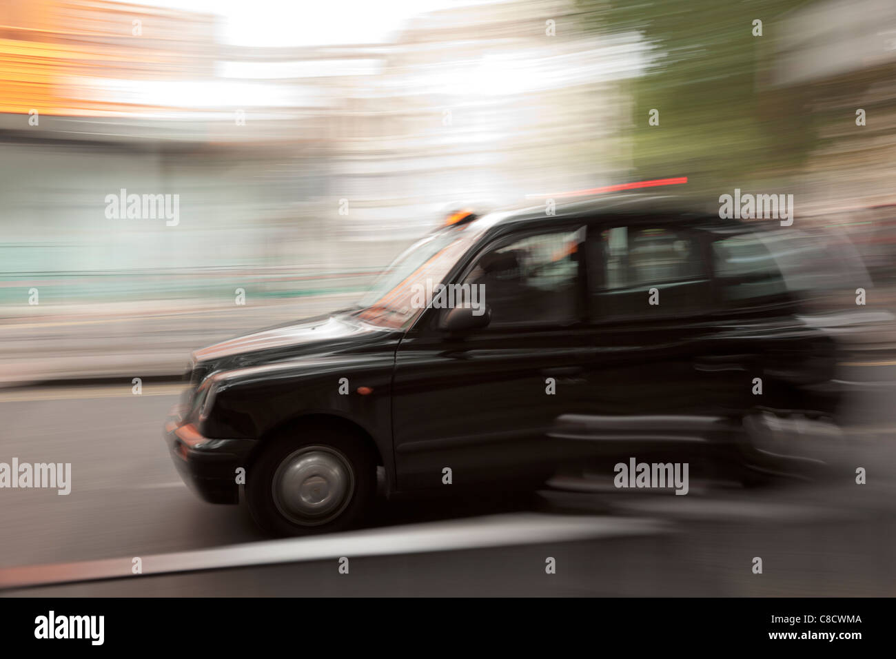 Fast moving London Taxi Stock Photo