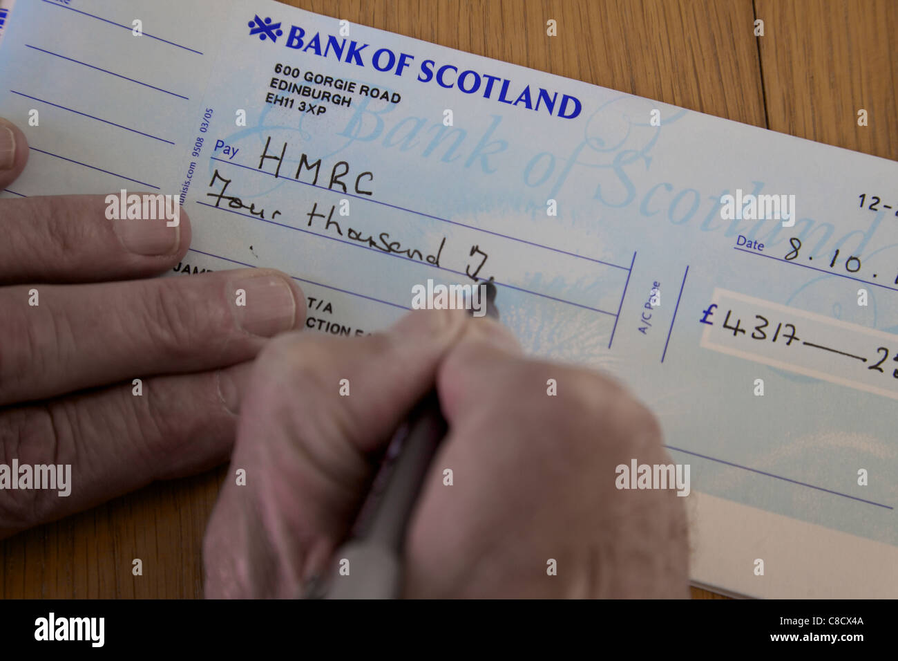 Writing a cheque for HMRC tax, England Stock Photo - Alamy
