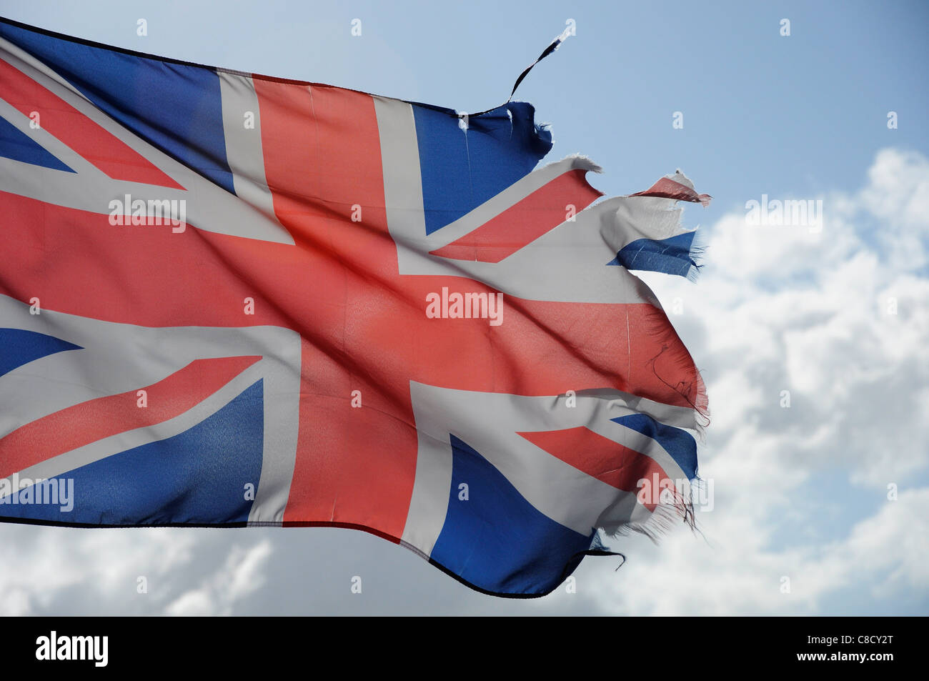Union Jack flag with ragged tattered edge austerity recession UK economy concept. Stock Photo
