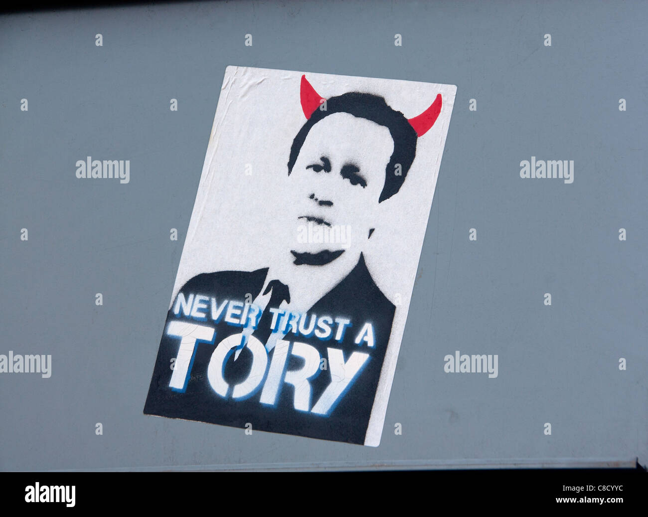 Never Trust A Tory Poster artwork of Prime Minister David Cameron with red devil horns Roath Cardiff Wales UK Stock Photo