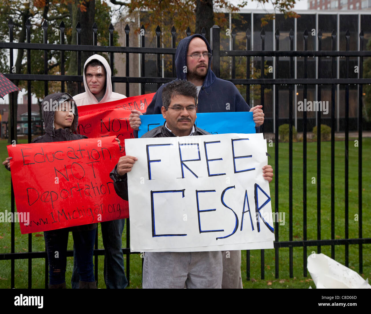 Detroit, Michigan - People picket the Immigration and Customs Enforcement office in a heavy rain storm to protest the pending deportation of Cesar Montoya. He was brought to the U.S. ten years ago at age 14, and would be eligible to stay under the DREAM Act, if passed by Congress. Stock Photo