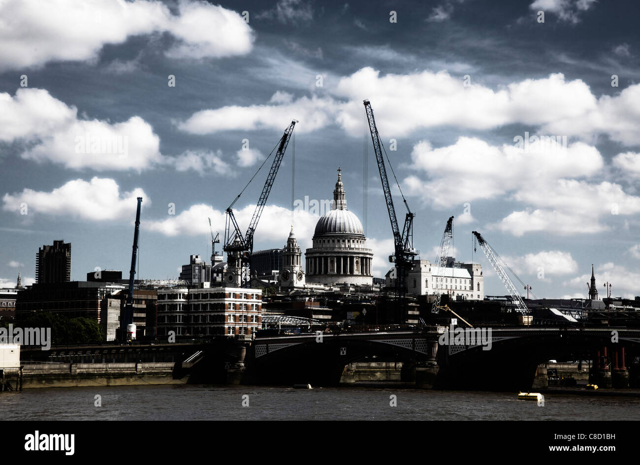 St Pauls Cathedral dome framed by modern cranes, London in high contrast Stock Photo