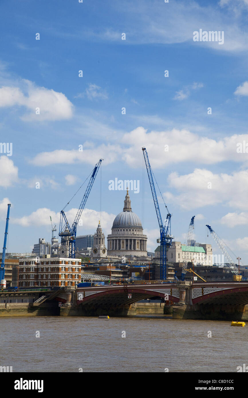St Pauls Cathedral dome framed by modern cranes, London Stock Photo