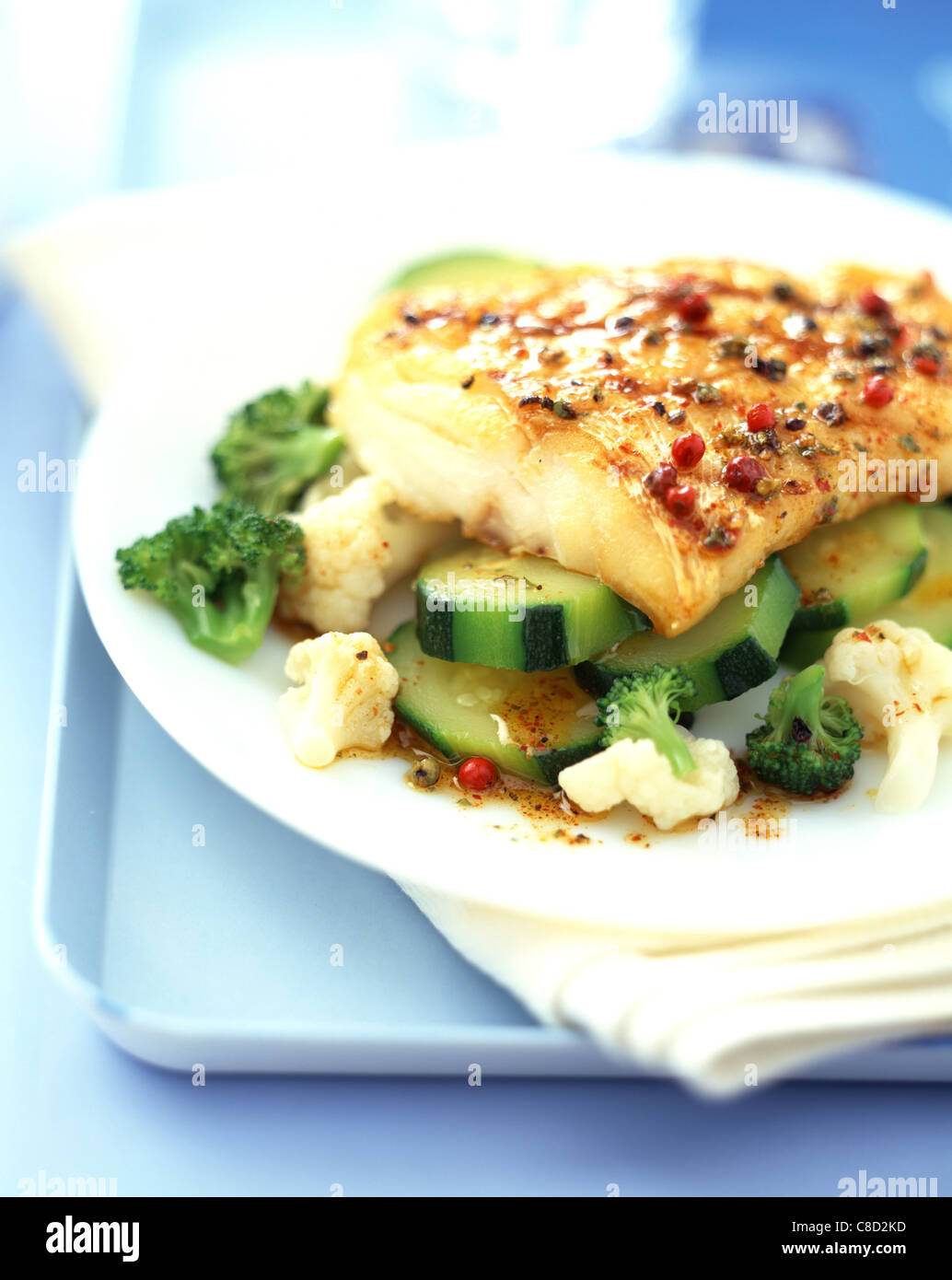 fillet of fish with peppercorns, courgettes and cauliflower Stock Photo ...