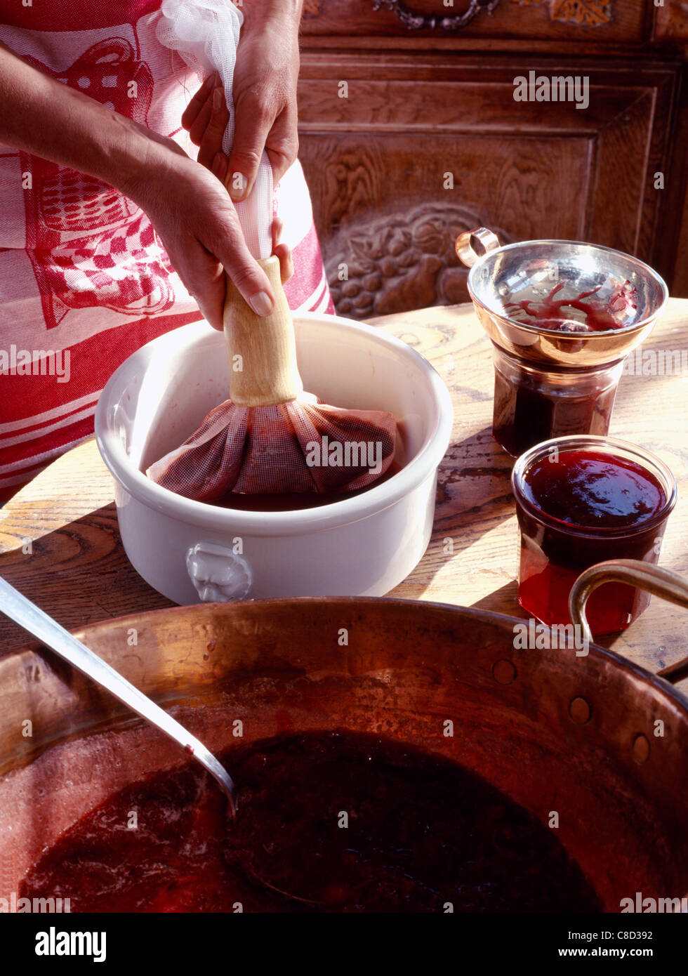 Preparing raspberry wine and wild strawberry jelly Stock Photo - Alamy