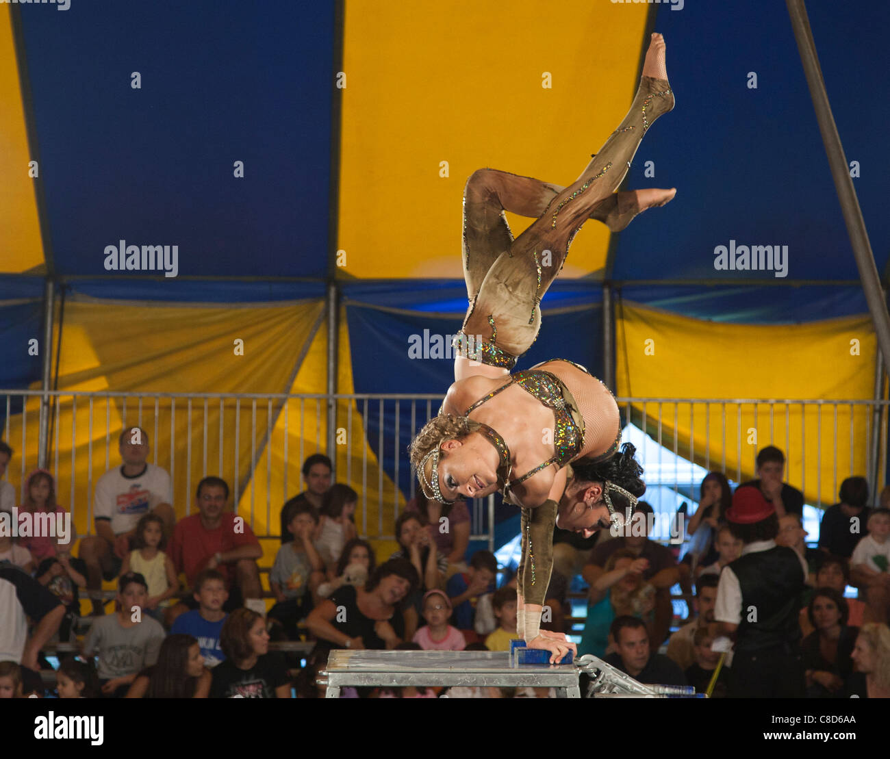 Acrobat performing in a circus tent Stock Photo