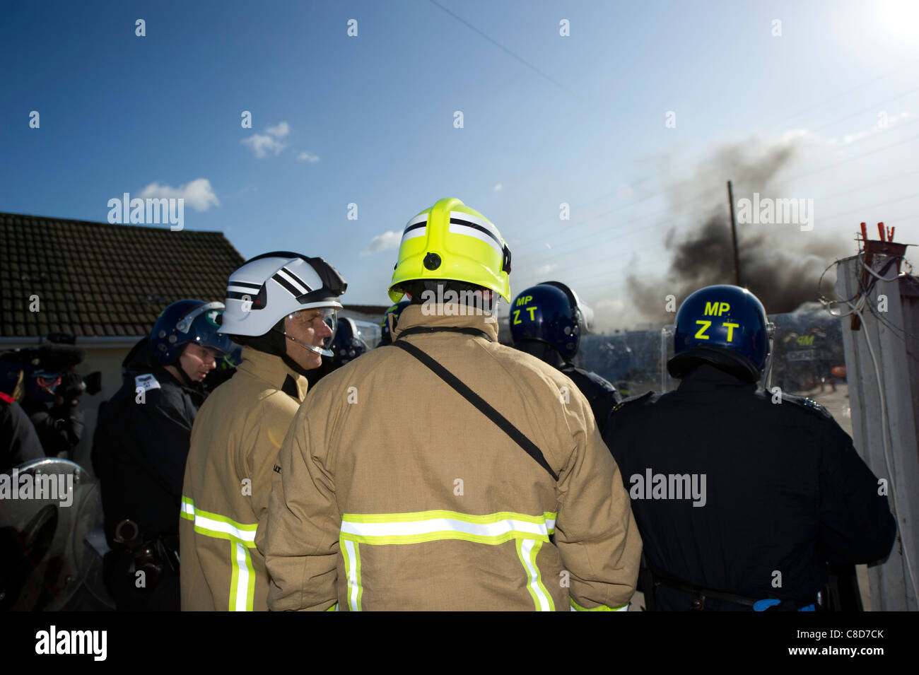 Senior fire officers behind police line assess a fire that was started during the Dale Farm eviction process. Stock Photo