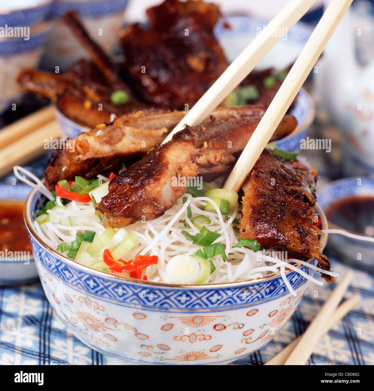 Spiced spare ribs and vegetable rice noodles Stock Photo Alamy