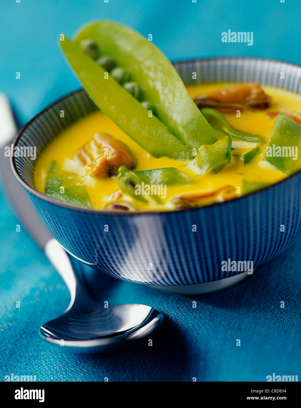 Creamed curried mussels and sugar peas Stock Photo Alamy