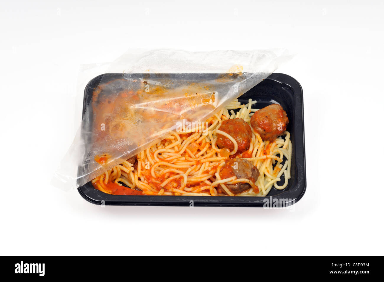 Tray of microwave spaghetti and meatballs with plastic cover still on