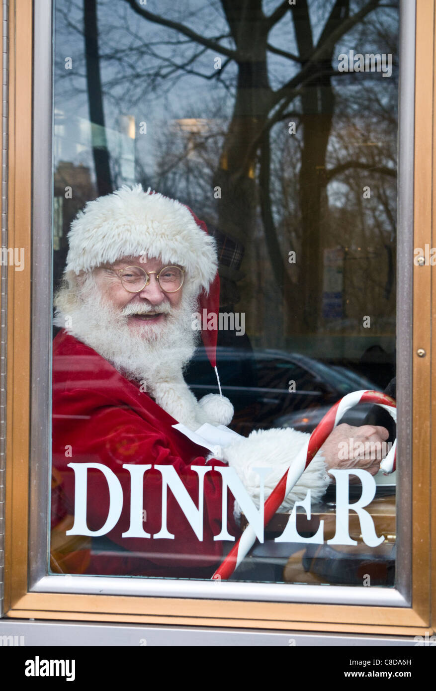 Santa Claus eating lunch in NYC restaurant window during Xmas holiday