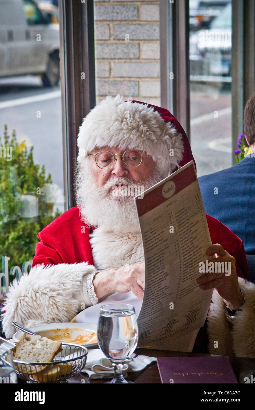 Santa Claus eating lunch in NYC restaurant window during Xmas holiday