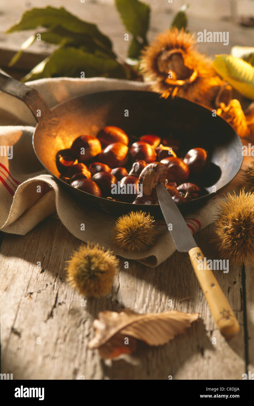 Roasting chestnuts in a frying pan Stock Photo Alamy