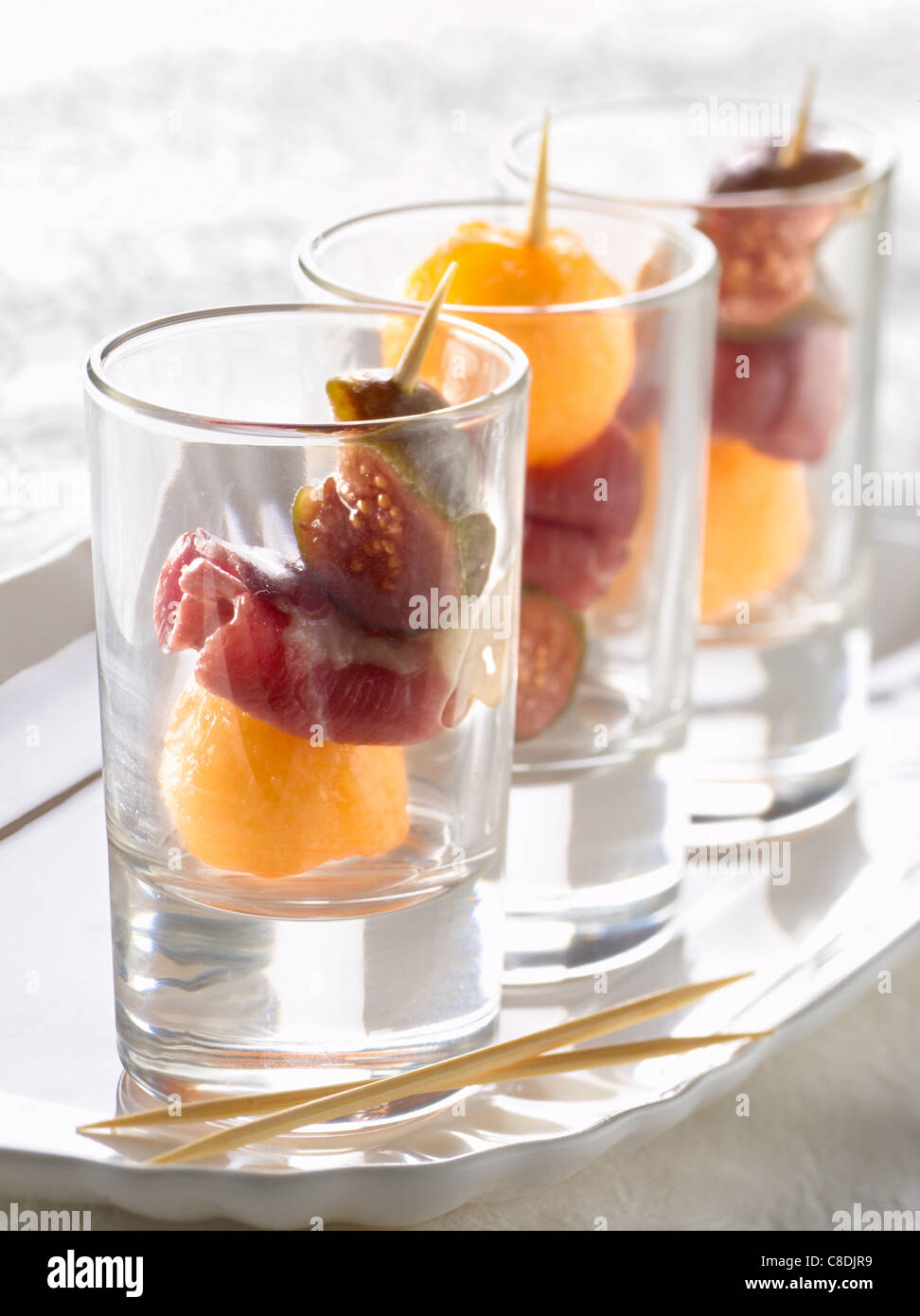 Smoked duck Magret ,fig and melon small skewers Stock Photo
