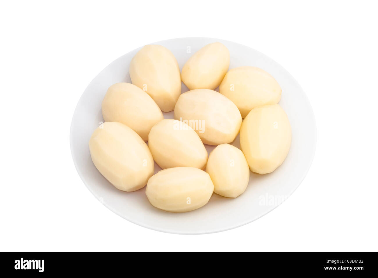 Peeled potatoes on plate, isolated on white background. Stock Photo