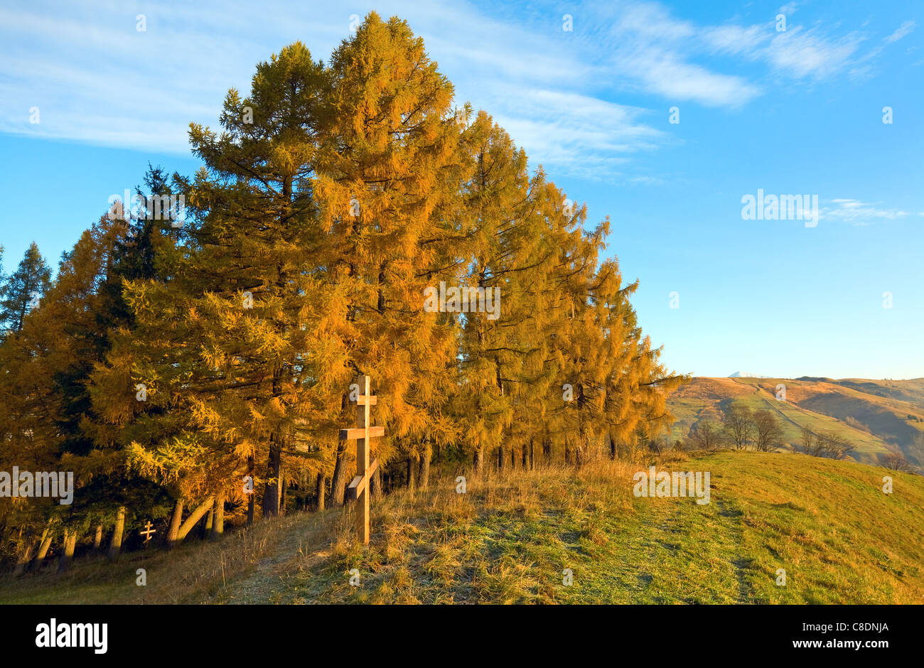 Autumn morning mountain view with wooden cross on hill (Carpathian, Ukraine) . Stock Photo