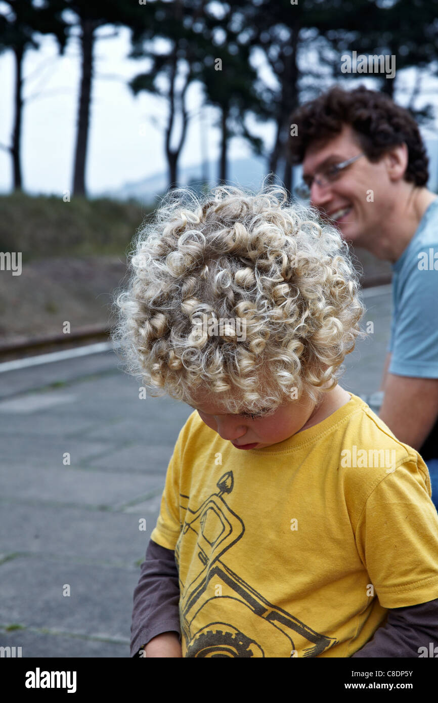 Young Boy Sporting A Mass Of Naturally Blonde Curly Hair Stock