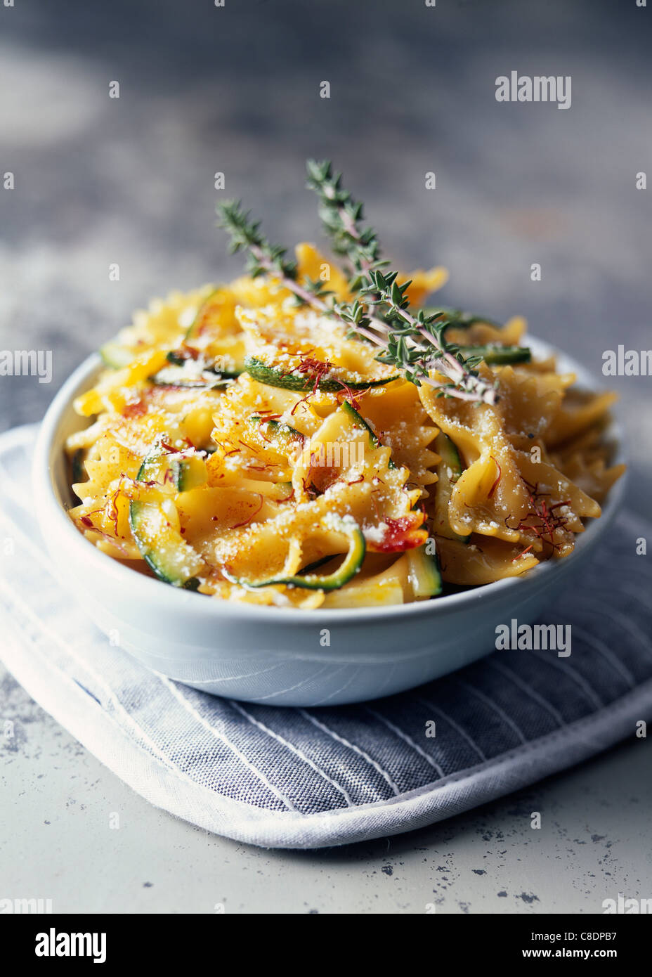 Farfalle with zucchinis and saffron Stock Photo