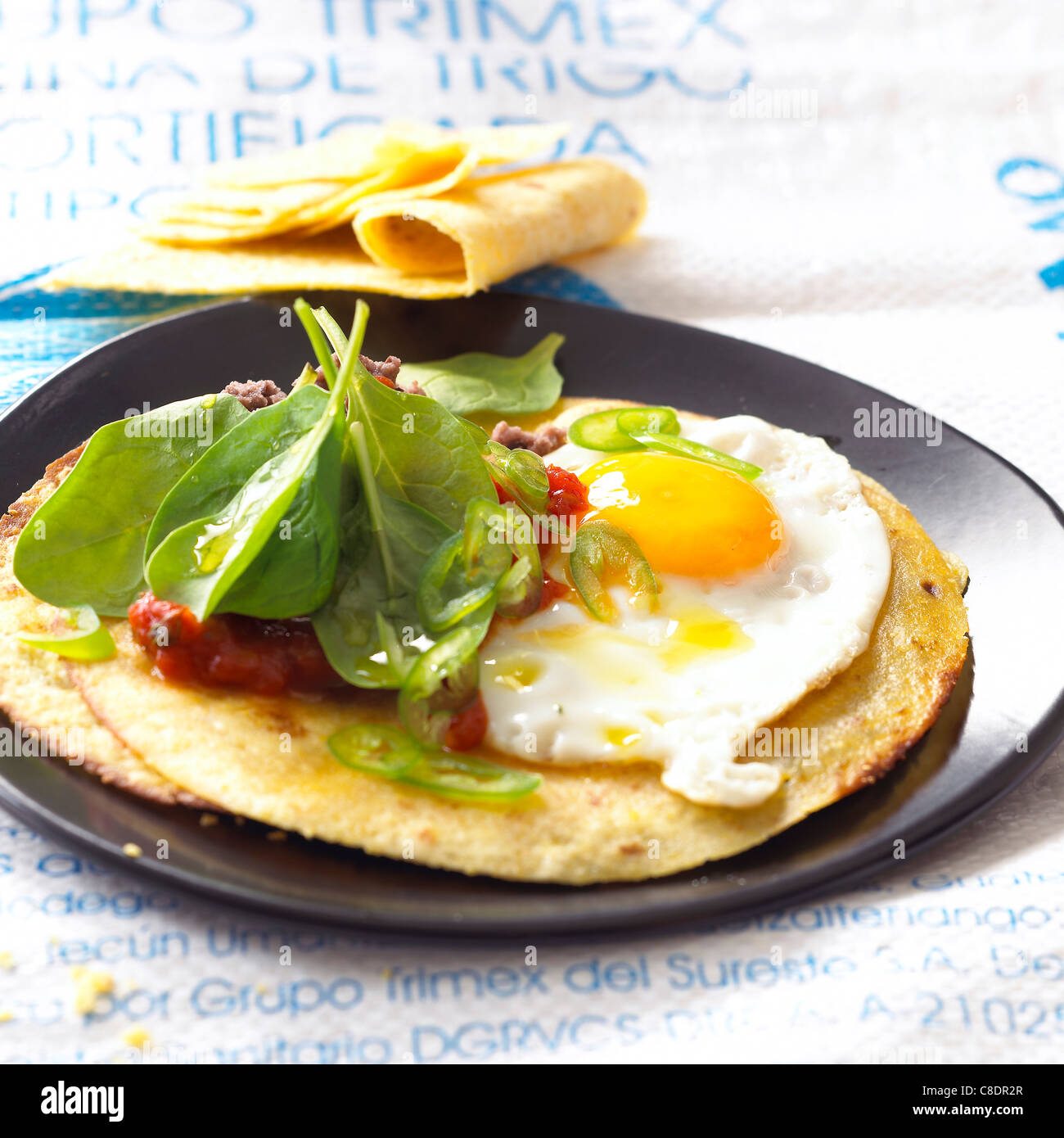 Savoury pancakes with fried egg,tomato and raw spinach Stock Photo Alamy
