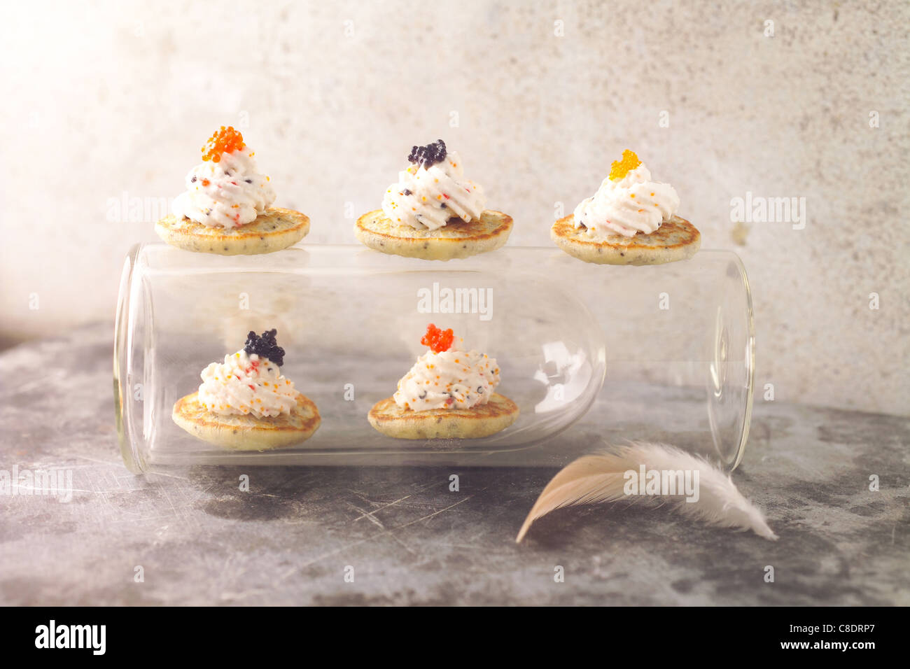 Mini blinis with whipped cream and multicolored fish roe Stock Photo ...