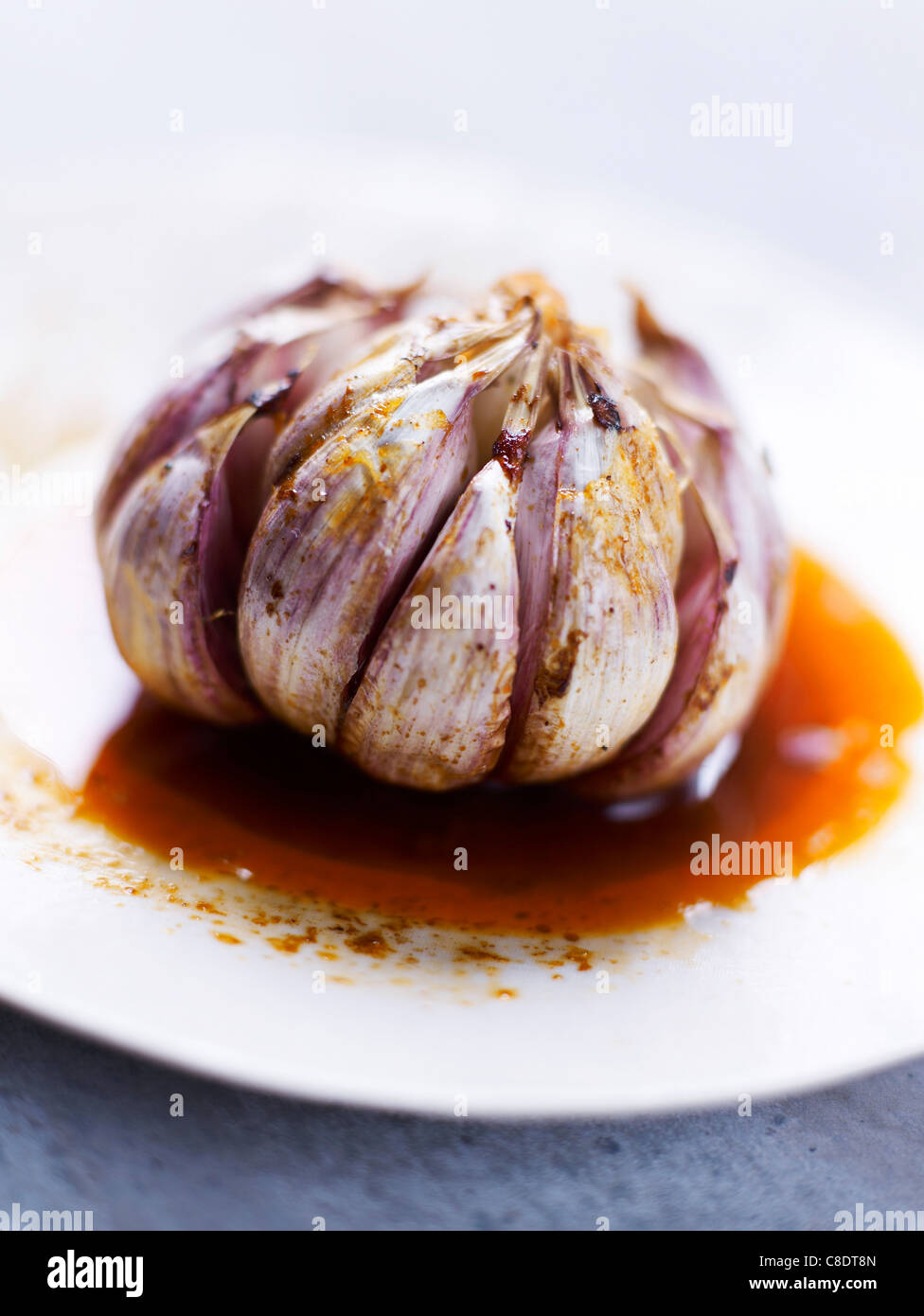Confit pink garlic head Stock Photo Alamy
