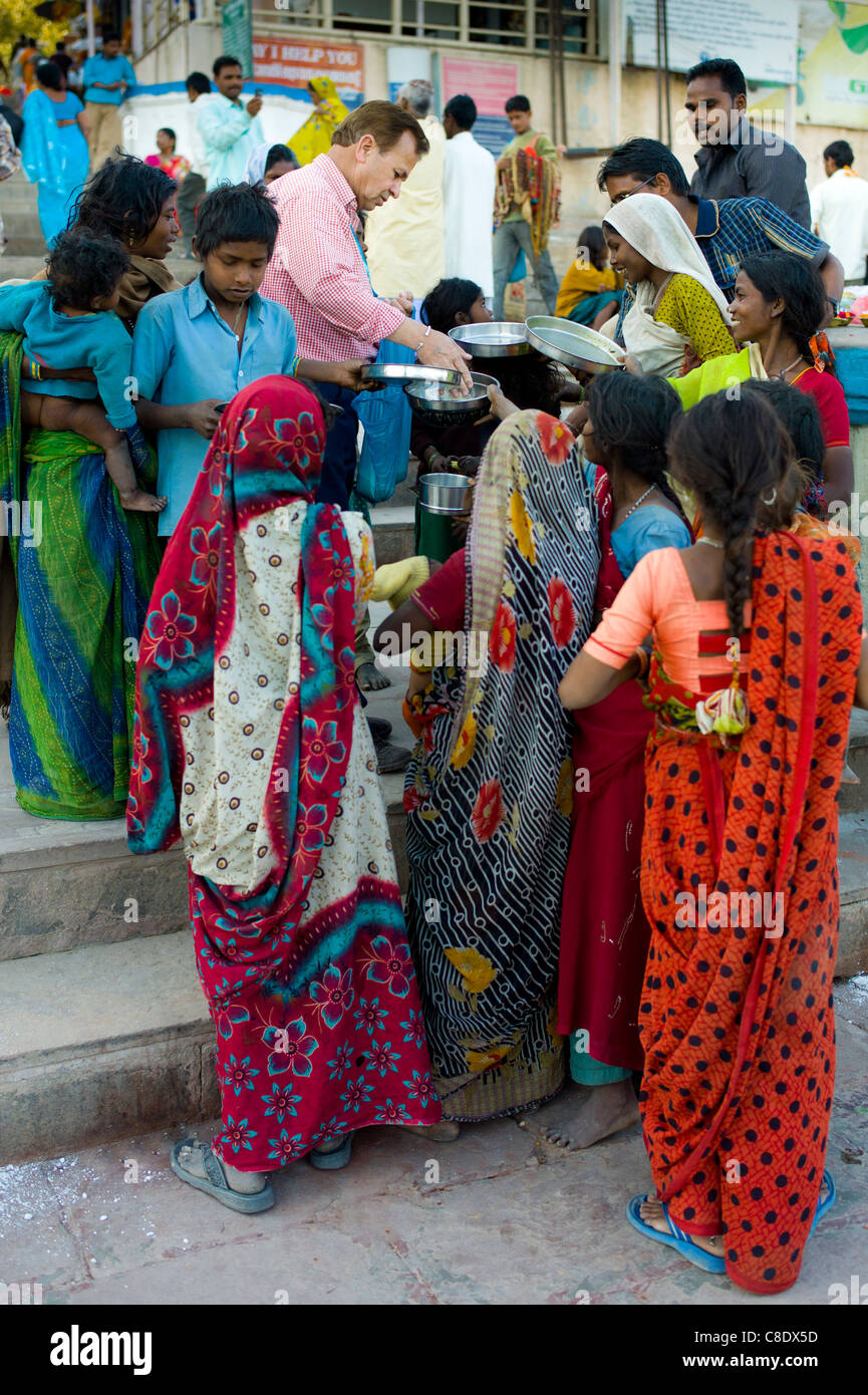 Food aid for the poor at Dashashwamedh Ghat in Holy City of Varanasi, Benares, India Stock Photo