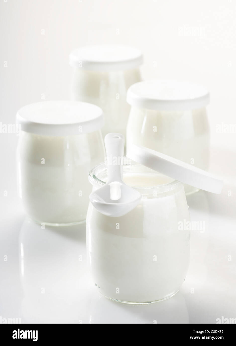 Yoghurts in glass pots Stock Photo Alamy