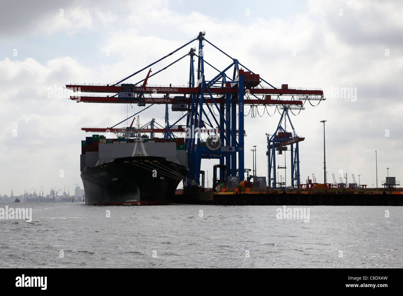 A container ship is unloaded at the Burchardkai Container Terminal in Hamburg, Germany. Stock Photo