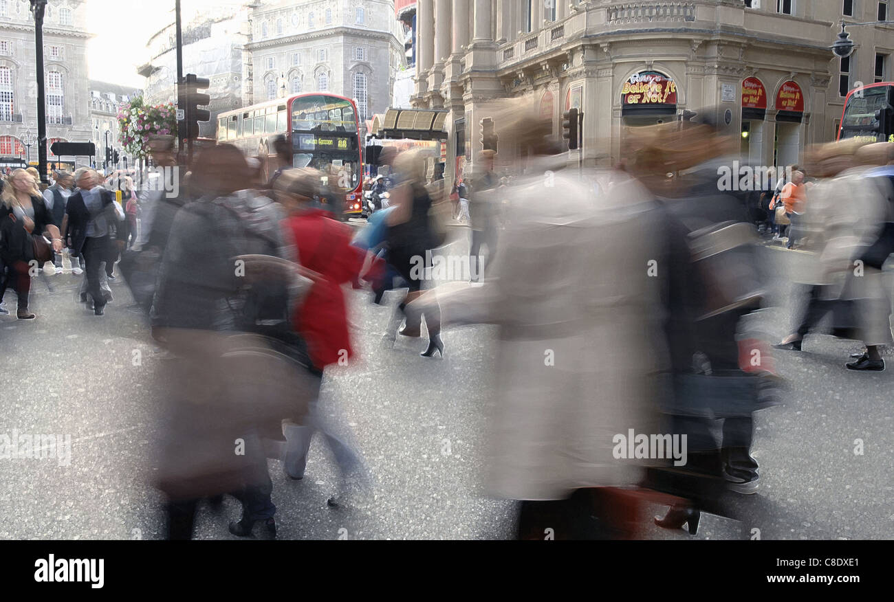 London street scene with tourists and shoppers. Slow exposure and Photoshop treatment to give a vibrant, busy and graphic feel. Stock Photo